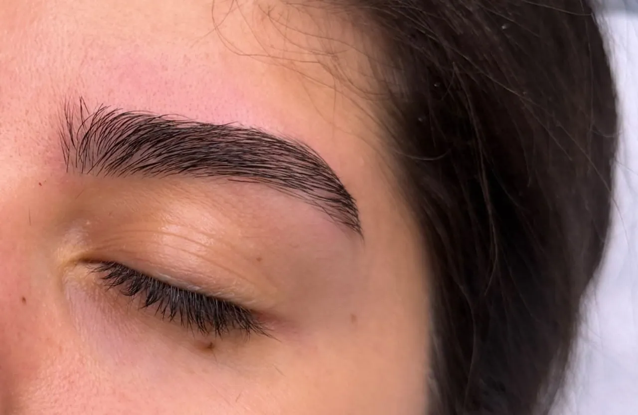 Eyebrow after tweezing and styling, with a defined contour