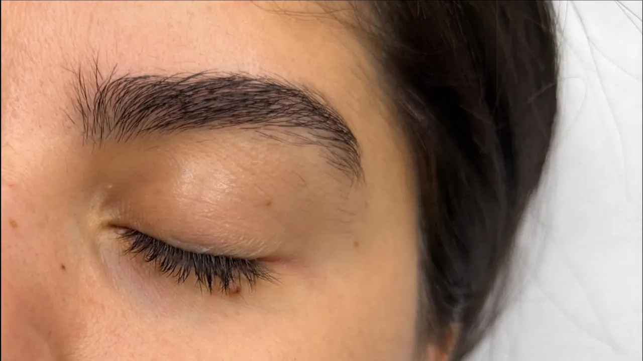 Eyebrow before tweezing and styling, showing the existing hairs